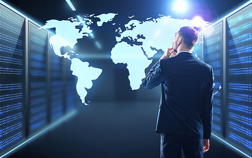 business, people and technology concept - businessman with virtual world map projection over server room background