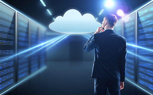 business, people and technology concept - businessman in suit looking at virtual cloud hologram over server room background