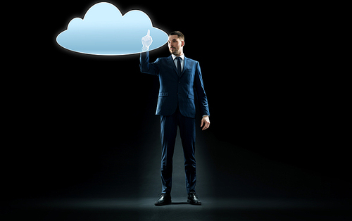 business, people and technology concept - businessman in suit touching virtual cloud hologram over black background