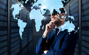 business, people and technology concept - businessman in virtual reality headset with world map projection over futuristic server room background