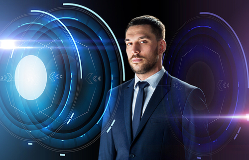 business, people and technology concept - businessman in suit over black background with holograms