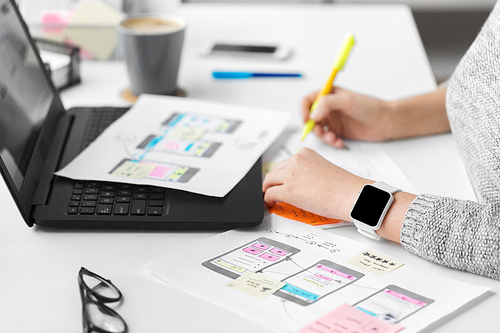 app design, technology and business concept - web designer with smart watch working on user interface and creating layout at office