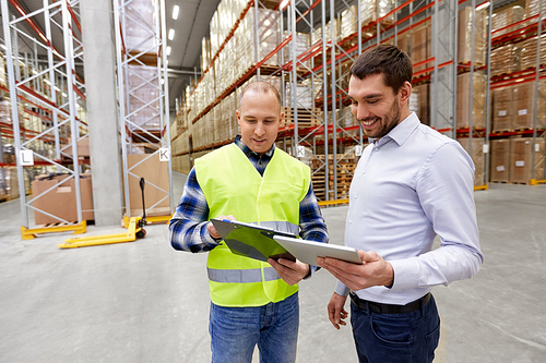 logistic business, shipment and people concept - warehouse worker and businessman with clipboard and tablet pc computer