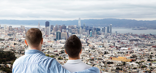 homosexual, same-sex marriage and tolerance concept - close up of happy male gay couple hugging over san francisco city view background
