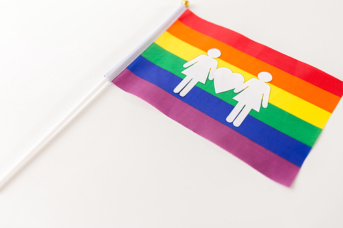 gay pride, homosexual and lgbt concept - rainbow flag with female couple white paper pictogram