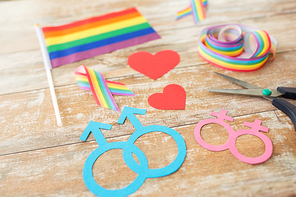 homosexual and lgbt concept - scissors and gay party props on wooden boards