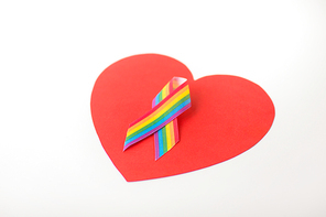 homosexual and lgbt concept - gay pride awareness ribbon on red heart shape over white background