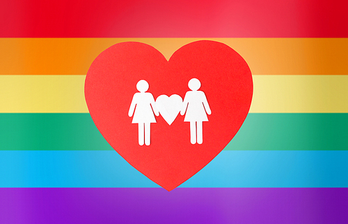 gay pride, homosexual, valentines day and lgbt concept - female couple white paper pictogram on red heart over rainbow background