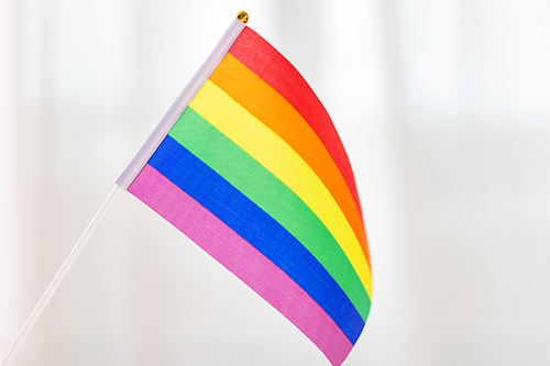 gay pride, homosexual and lgbt concept - close up of rainbow flag