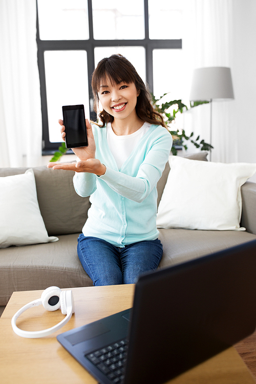 blogging, technology and videoblog concept - happy smiling asian woman or . recording video blog of smartphone at home