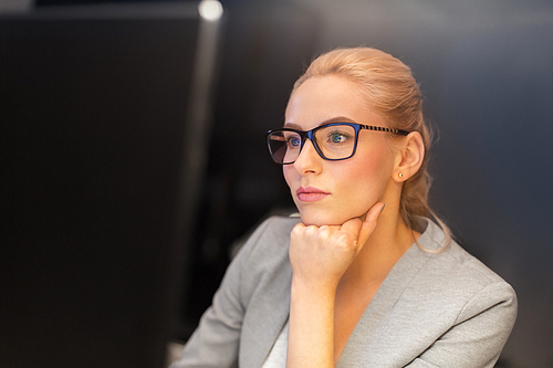 business, overwork, deadline and people concept - businesswoman in glasses working at computer in night office