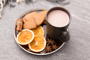drinks and season concept - cup of hot chocolate with dried orange, gingerbread cookies, cinnamon and anise on plate or tray