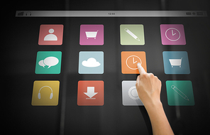 technology and people concept - hand using interactive panel with app icons on it