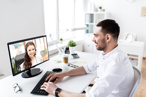 business, people and technology concept - businessman having video call with customer service operator or partner on pc computer at office