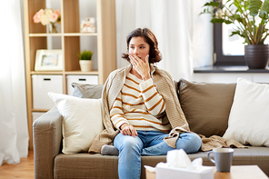 cold and health problem concept - sick woman in blanket coughing at home