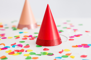party props, accessory and festive concept - red birthday cap and confetti