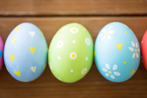 easter, holidays, tradition and object concept - close up of colored eggs