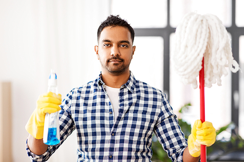 cleaning, housework and housekeeping concept - indian man with mop and detergent at home