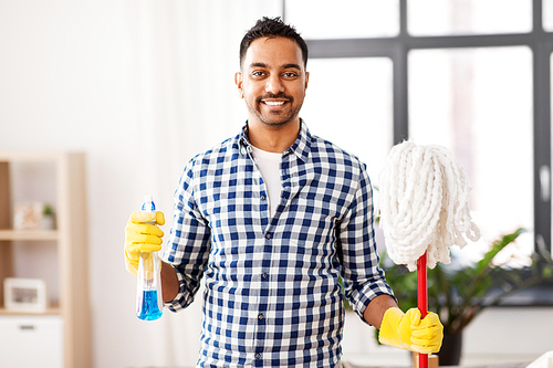 cleaning, housework and housekeeping concept - smiling indian man with mop and detergent at home