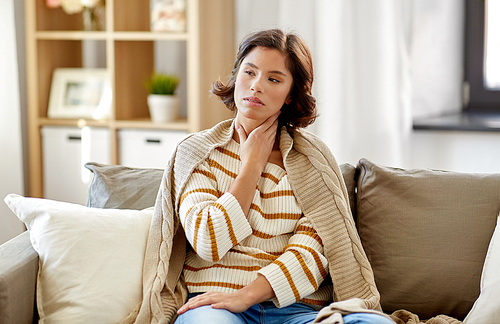 cold and health problem concept - unhappy sick woman with sore throat at home