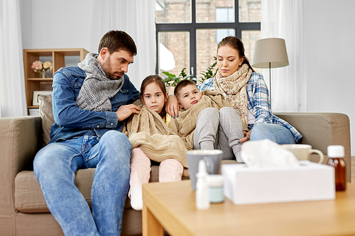 family, health and people concept - sick father, mother and ill children having flu at home