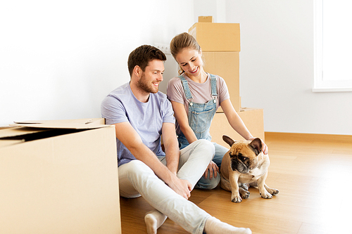 mortgage, people and real estate concept - happy couple with boxes and french bulldog dog moving to new home