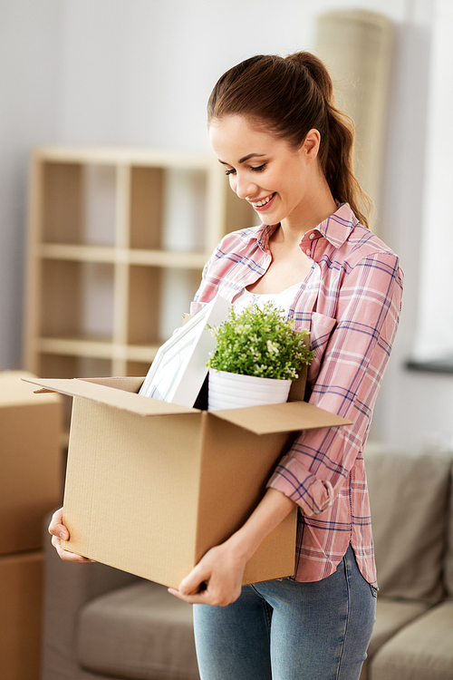 people, repair and real estate concept - smiling woman with stuff moving to new home