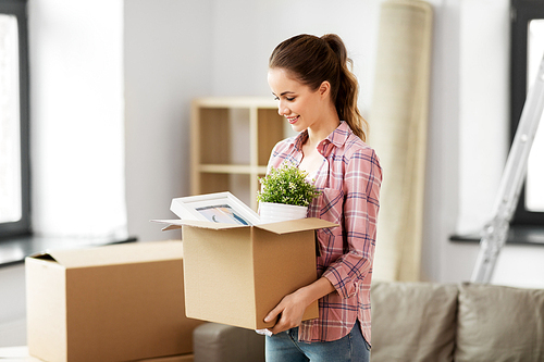 people, repair and real estate concept - smiling woman with stuff moving to new home