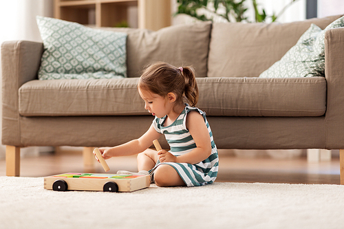 childhood and people concept - happy three years old baby girl playing with toy blocks at home