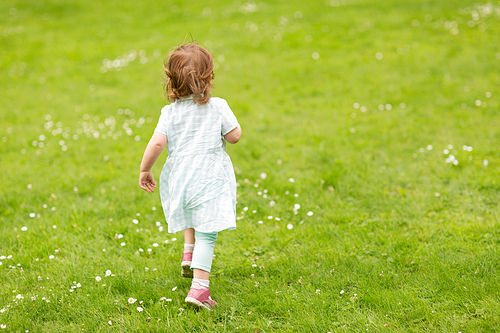 childhood, leisure and people concept - happy little baby girl running at park in summer