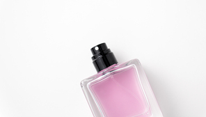 fragrance and aroma concept - bottle of perfume or pink toilette water on white background