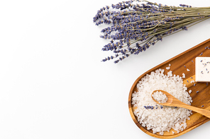 beauty and wellness concept - sea salt heap, lavender and spoon on wooden tray