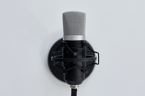 technology and audio equipment concept - close up of microphone on white background