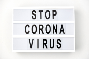 medicine, epidemic and healthcare concept - lightbox with stop coronavirus caution words on white background