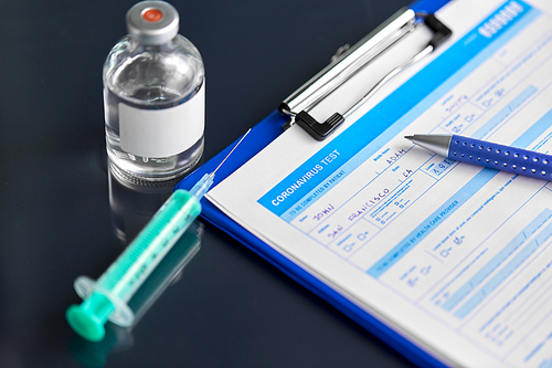 medicine and healthcare concept - close up of clipboard with medical report, pen, syringe and drug on table