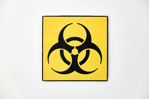 science, toxic and pandemic concept - biohazard caution sign on white background