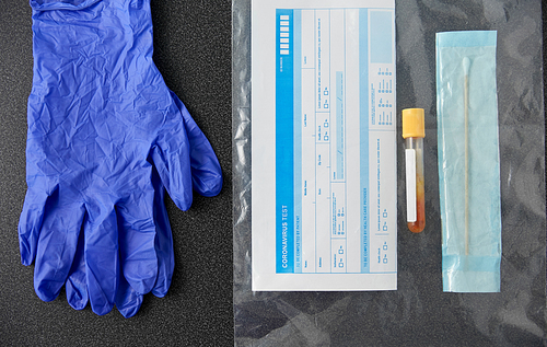 medicine, healthcare and pandemic concept - test tube, cotton swab and medical report in plastic zipper bag and protective gloves on table