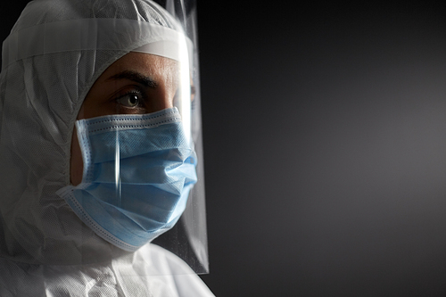 health safety, medicine and pandemic concept - close up of female doctor or scientist in protective wear, medical mask and face shield for protection from virus disease