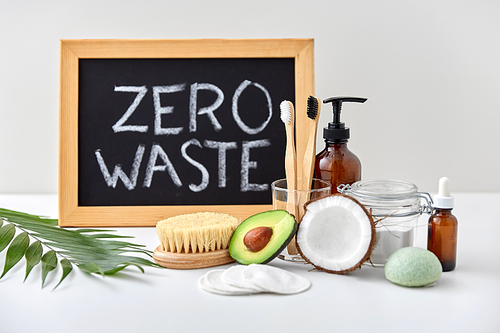 beauty, sustainability and eco living concept - natural cosmetics, bodycare, hygienic eco products and chalkboard with zero waste words or lettering on white background