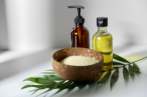 natural cosmetics, sustainability and eco living concept - 씨솔트 in bowl, liquid soap or shower gel, massage oil and palm leaf on white background