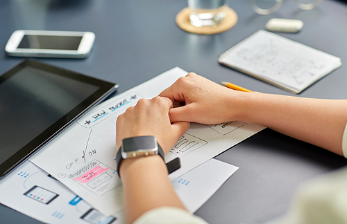 business, people and technology concept - close up of ui designer with mockups working on mobile app design at office