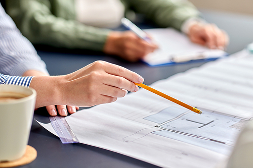 construction business, architecture and team work concept - close up of architects with blueprint, gadgets and papers working at office table