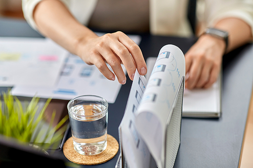 business, people and technology concept - close up of ui designer with mockups working on mobile app design at office