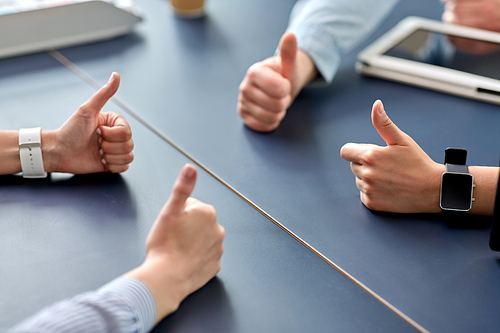 success, business and team work concept - close up of hands showing thumbs up