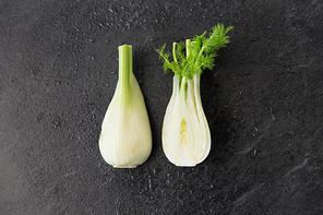vegetable, food and culinary concept - fennel on slate stone background