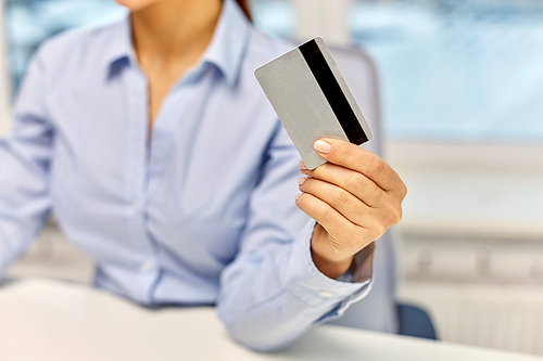 technology, age and people concept - close up of businesswoman with credit card at office