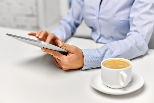 business, technology and people concept - businesswoman with tablet pc computer drinking coffee at office