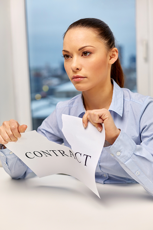 business agreement and legal concept - businesswoman terminating contract at office