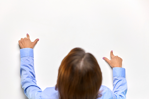 business and people concept - close up of businesswoman touching white board or table with fingers