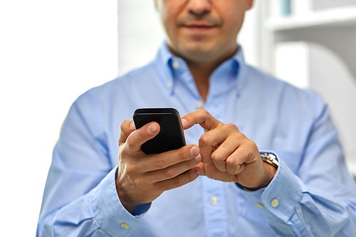 business, people and technology concept - close up of businessman using smartphone